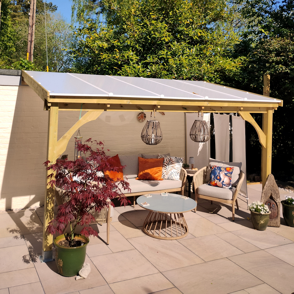 Outdoor patio area with a wooden gazebo, seating, and decorative elements.