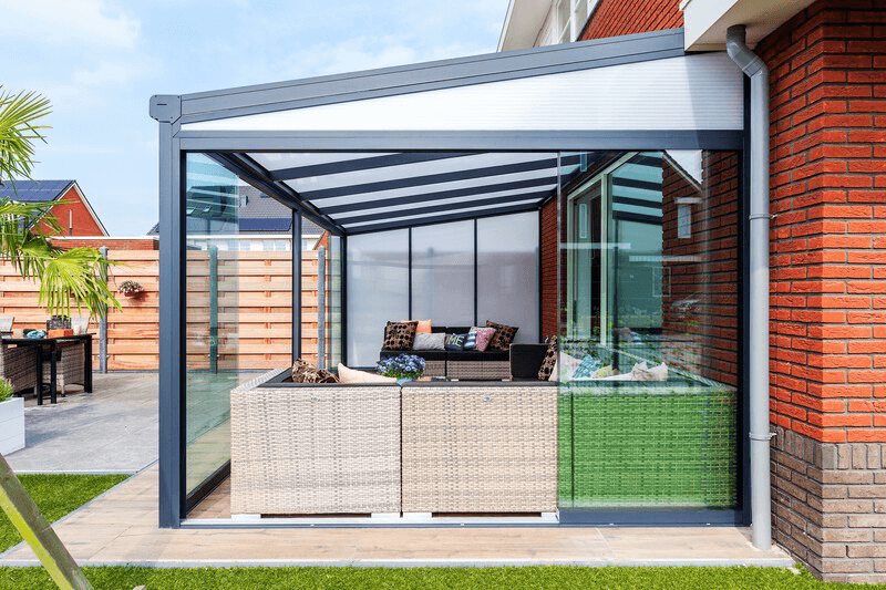 Outdoor patio area with a pergola and furniture on a sunny day.