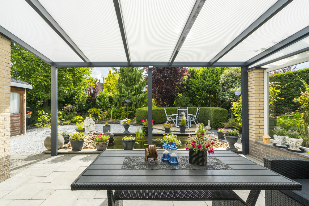 Patio with outdoor furniture, table, and decorative elements under a veranda.