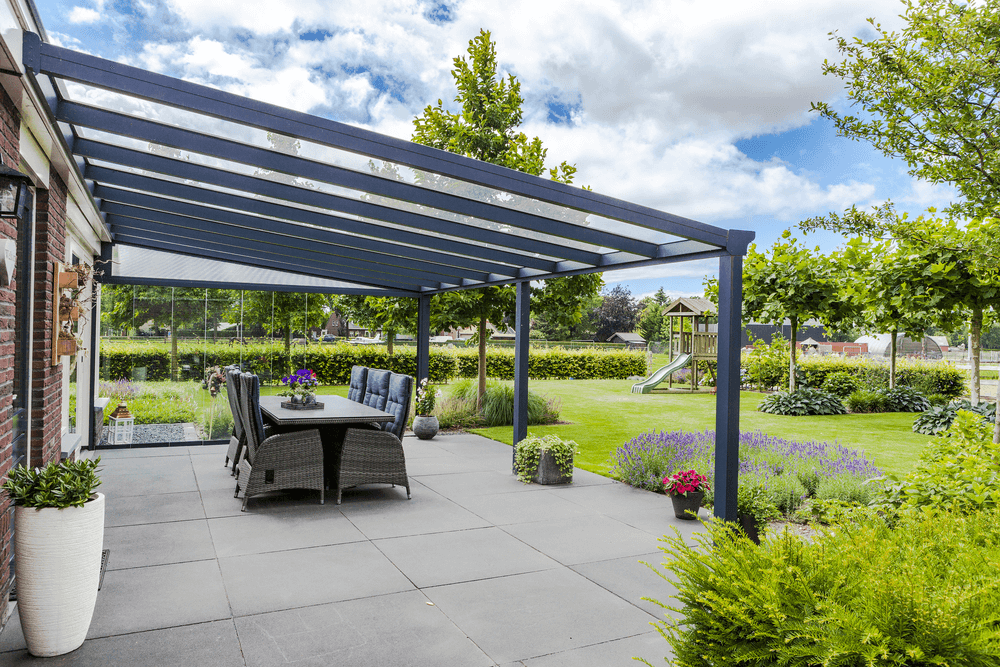 Outdoor patio with pergola, dining table, and garden view