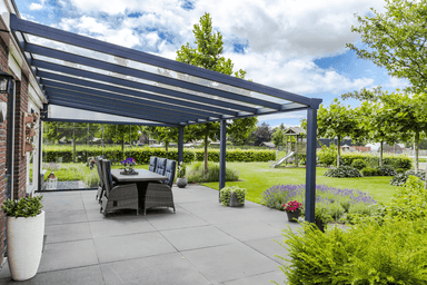Outdoor patio with pergola, dining table, and garden view