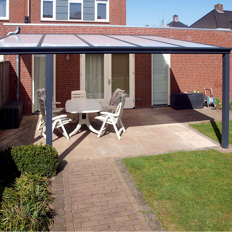 Patio area with Deponti Bosco Veranda, table, and chairs in front of a brick house.
