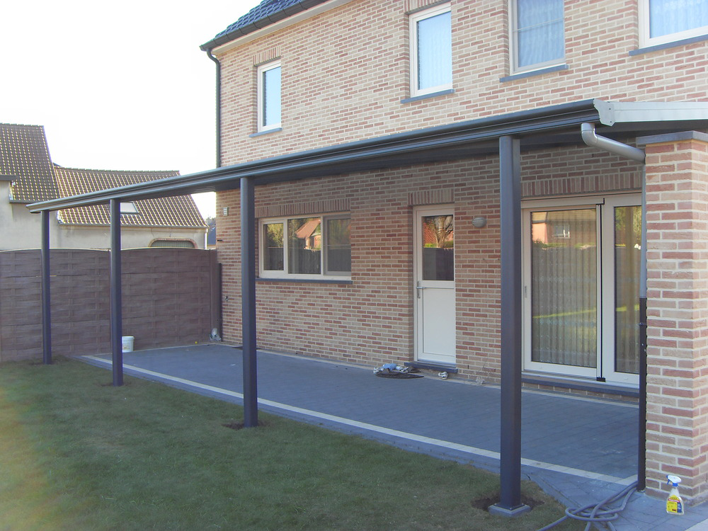 Patio cover attached to a brick house with a clear sky background