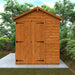 Wooden shed with double doors in a garden setting
