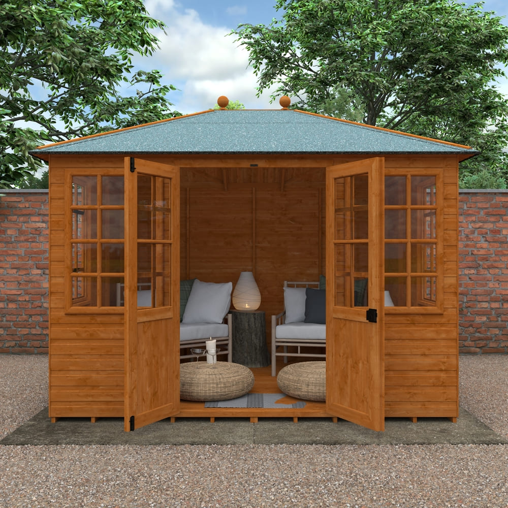 Wooden summerhouse with open doors, featuring furniture and decor, set against a natural background.