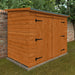 Wooden shed with double doors against a brick wall and greenery