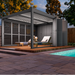 Modern pool house with lounge chairs by a pool in a backyard setting.