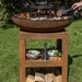 Food cooking on the HEAT Bakka plancha with a pan on the Turret grill