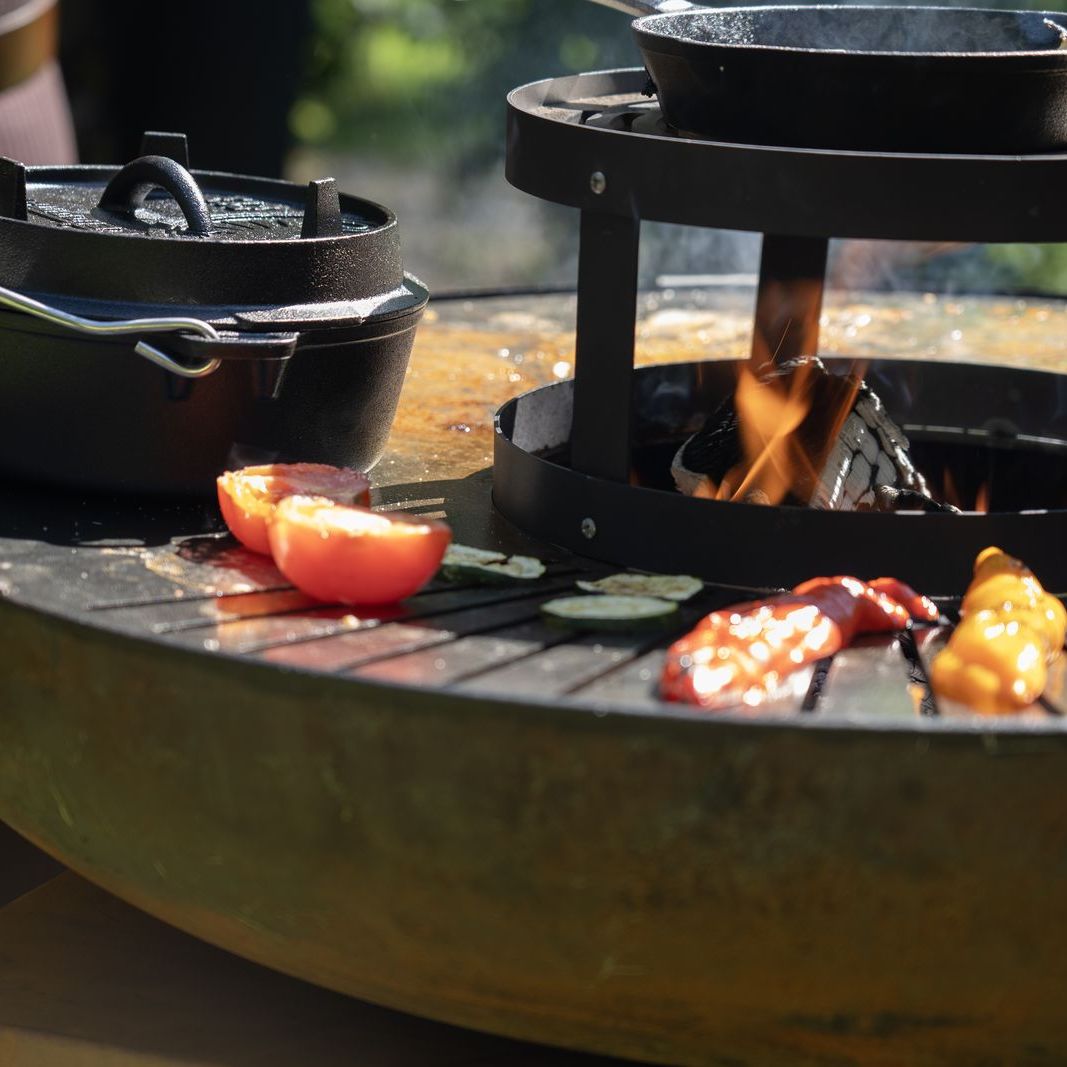 Close-up of food on the HEAT Bakka plancha ring around the fire