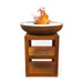 HEAT Bakka rust plancha grill with a fire and log storage shelves, on a white background