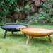 HEAT Classic black and rust fire bowls on legs side by side on the lawn