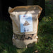 HEAT natural wood fibre firelighters in a 1kg bag on a lawn