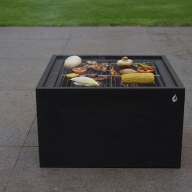 HEAT 3 in 1 used as a BBQ on a patio with food on the grill