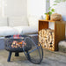 HEAT Alna fire pit burning on a patio beside a sofa and log store