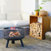 HEAT Alna fire pit with a fire on a patio next to stacked logs