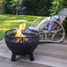 HEAT Boble fire bowl with a fire on a garden deck next to a rattan chair