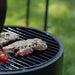Steak and tomatoes cooking on the HEAT Braten grill