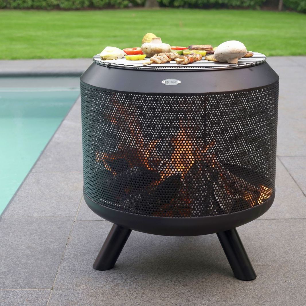 Food cooking on the HEAT Fire Drum grill by a swimming pool