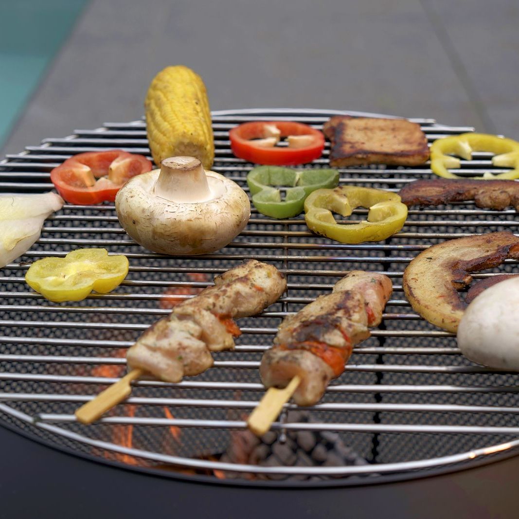 Kebabs, corn and vegetables on the HEAT Fire Drum grill grid