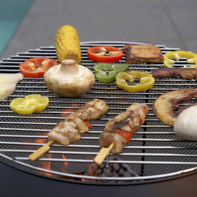 Kebabs, corn and vegetables on the HEAT Fire Drum grill grid
