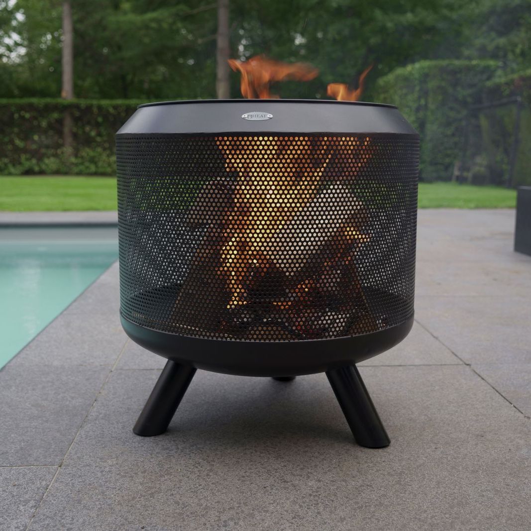 HEAT Fire Drum with logs burning on a paved patio