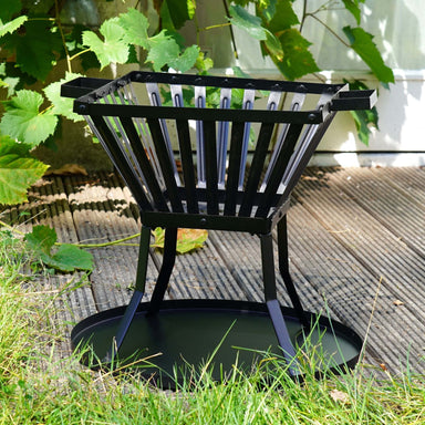 HEAT Skal square fire basket on a round base plate on garden decking