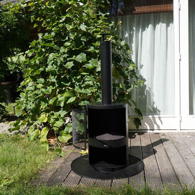 HEAT Hamar outdoor fireplace on a base plate on garden decking