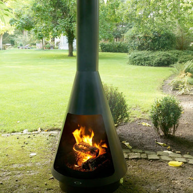 HEAT La Luz chiminea burning by a garden path at dusk