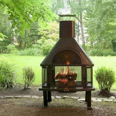 HEAT Saga chiminea with a fire burning, standing on a garden lawn