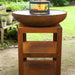 HEAT Turret grill with a fire inside, fitted on a Bakka plancha in a garden