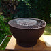 HEAT Trolle fire bowl with grill fitted on the griddle, garden view