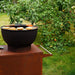 Food cooking on the HEAT Trolle griddle in a garden