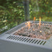 Flames rising through lava stones in the HEAT Utevarme burner
