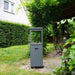 HEAT Utevarme patio heater in the corner of a lawned garden