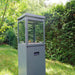 HEAT Utevarme grey patio heater on grass by a hedge