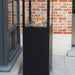 HEAT Utevarme black patio heater against a brick wall