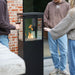 People standing round a HEAT Utevarme patio heater with drinks