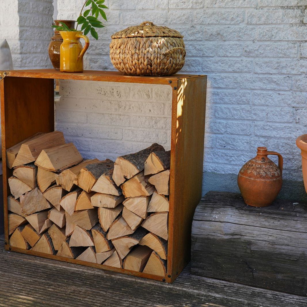HEAT Dokka rust steel log store filled with logs on a patio
