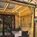 Outdoor patio area with wooden gazebo, table, and chairs.