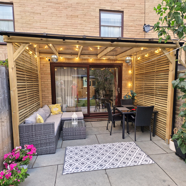Outdoor patio area with wooden gazebo, seating, and table.